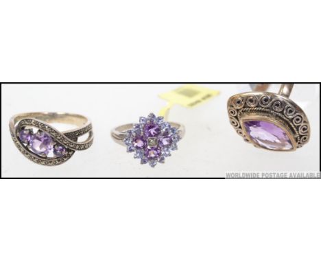 A collection of three boxed silver ( 925 stamped ) amethyst set rings, each having a different design