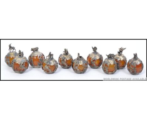 A stunning set of chinese silver and amber glass zodiac balls. 10 in total being embellished with dragons to each. Atop each 