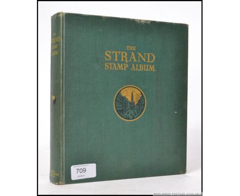 A vintage ' Strand ' stamp album, filled with various stamps - overseas and GB. Mostly George VI, some Victorian and others. 