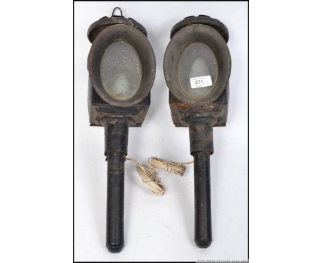 A pair of vintage cast and pressed metal carriage lamps, each retaining original glass and both being converted to electric. 