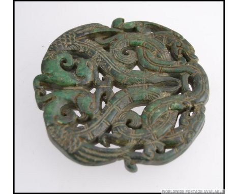 A large detailed jade roundel  decorated with birds and dragons.