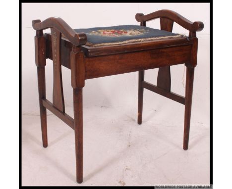An Edwardian mahogany stencil painted inlaid piano stool with blue tapestry upholstered seat with handles either side. H57 x 