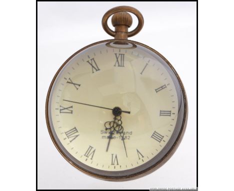 An antique style contemporary glass and brass ball clock.