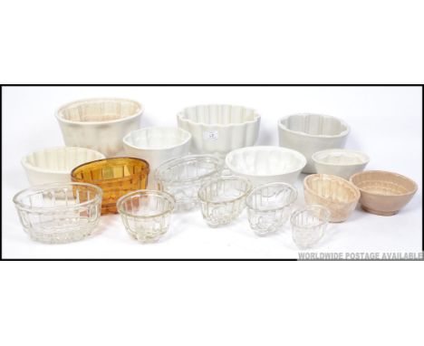 A large collection of Victorian and later jelly moulds to include several ceramic and glass moulds, various shapes and design