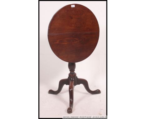 A Georgian 19th century mahogany tilt top tripod table  being raised on splayed legs with tilt to above on brass mechanism. H