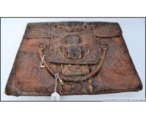 A vintage alligator leather ladies handbag, having lift up flap to reveal lined interior. W42cm 