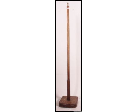 A 1930's Art Deco oak standard lamp raised on square terraced base with upright stem and shade