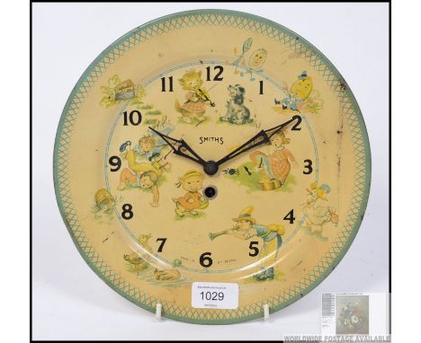A fantastic vintage early 20th century wall hanging mechanical tin plate clock by Smiths, the plate itself having various pri