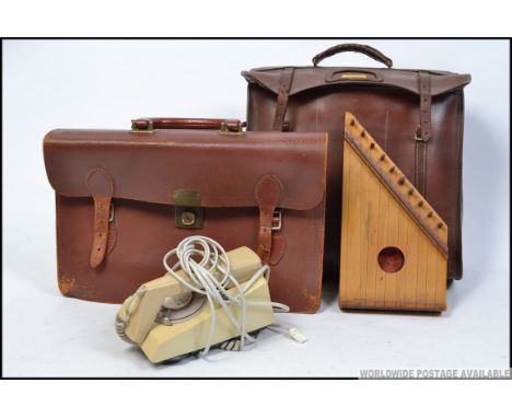 A vintage slimline ring dial BT telephone together with a vintage leather satchel and a wooden harpsichord musical instrument