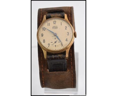 A 1950's Smiths Astral 15 Jewels Gentleman's brass and stainless steel wristwatch. Having numerals and arrow marked chapter r