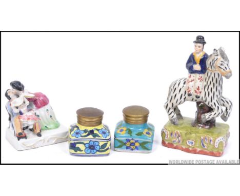 A Staffordshire flatback figurine of a zebra and seated gentleman together with a continental figurine diorama and 2 ceramic 