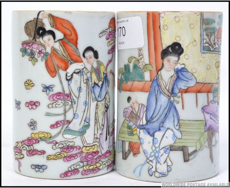 A fabulous pair of Chinese famille rose ceramic brush pots having decorative family scenes / scholars. Each with Ironstone re