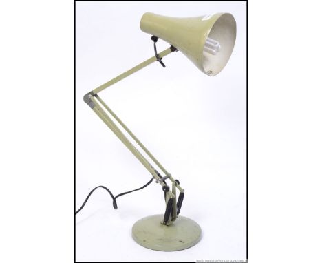 A mid century light green Herbert Terry anglepoise lamp with circular base and pendant shade