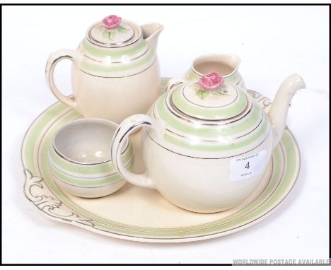 A 1930's Art Deco tea ceramic tea for one set. Comprising, tray, teapot, cup, sugar and creamer. Unsigned. W29cm 