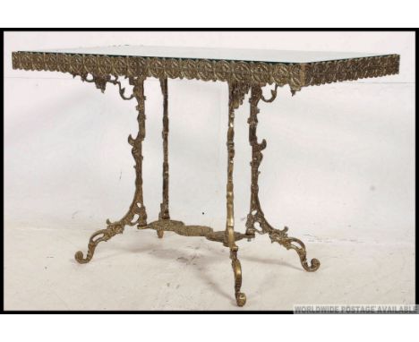 A 20th century vintage gilt cast metal coffee table base, having a fret pierced gallery raised on pedestal legs having a drop