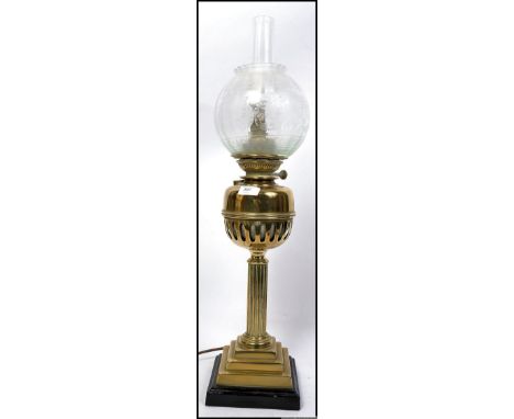 A stunning  early 20th century brass oil lamp of neo classical form with glass flue and stunning frosted and acid etched glob