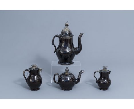 Full title: A silver mounted black glazed Namur pottery coffee pot, a teapot and two milk jugs, 18th C.Description: H 30,5 - 