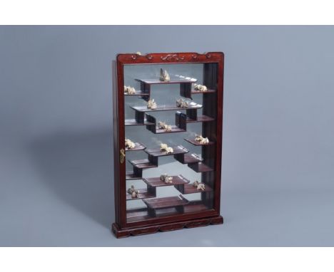 Full title: Twelve Japanese animal shaped netsuke in their display cabinet, first half of the 20th C.Description: 81,8 x 52,5