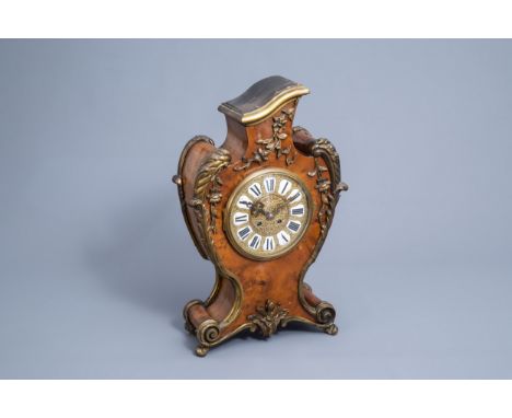 Full title: A German burl wood veneered brass mounted Louis XV style cartel clock, Uhrenfabrik MŸhlheim mark, 20th C.Descript
