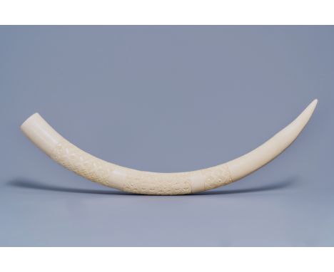 Full title: A carved ivory tusk with ornamental design, first half 20th C.Description: L 104 cm (outer curve)L 92 cm (inner c