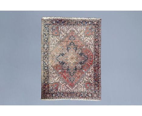 Full title: An Oriental Heriz rug with floral design and geometric motifs, wool on cotton, Northwest Persia, first half of th