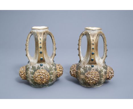 Full title: A pair of polychrome, gilt and iridescent Amphora Austria Art Nouveau relief decorated ceramic vases, first quart