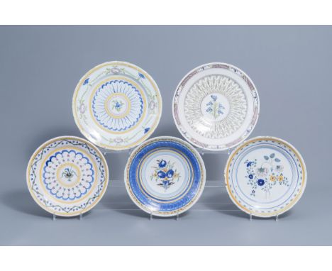 Full title: Five polychrome Brussels faience plates with floral design, 18th/19th C.Description: Dia.: 36 - 31,5 cm (the larg