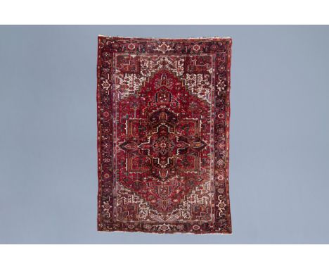 Full title: An Oriental Heriz rug with floral design and geometric motifs, wool on cotton, Northwest Persia, first half of th