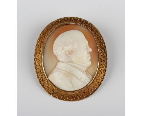 A Victorian gold oval shell cameo brooch, circa 1860, in the classical taste, carved as a portrait of a 19th century gentlema
