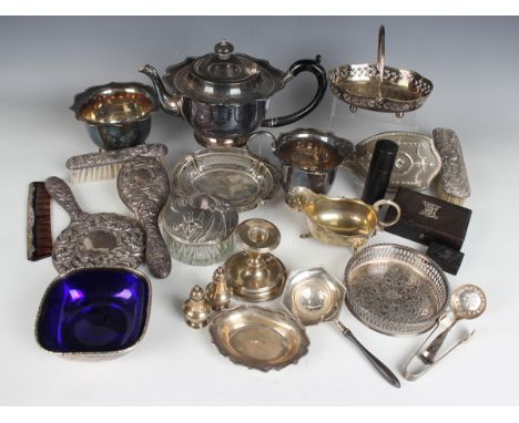 A small group of silver items, including a stub candlestick, Birmingham 1906, height 8cm, a tea strainer with turned wood han