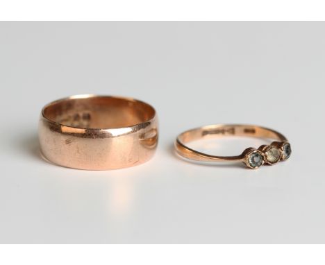 A 9ct gold wedding band, London 1916, ring size approx R, and a 9ct gold and paste three stone ring, Chester 1923, ring size 