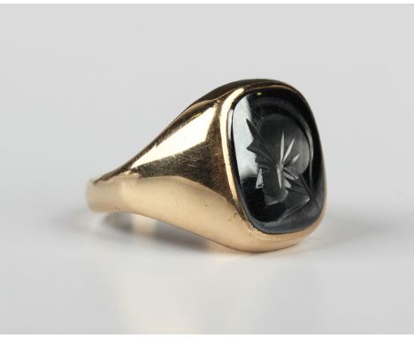 A 9ct gold and hematite intaglio ring, designed as a classical portrait, London 1974, weight 9.6g, ring size approx V.Buyer’s