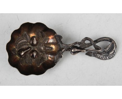 A mid-Victorian silver caddy spoon, the gilt lobed circular bowl embossed with fruit, the handle modelled as a fruiting stem,