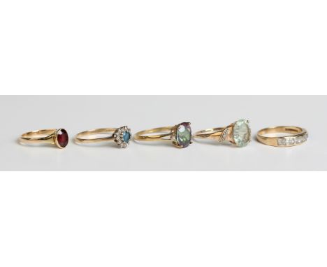 A gold ring, collet set with an oval cut garnet, detailed '18ct', weight 2.3g, ring size approx N, a 9ct gold diamond and blu