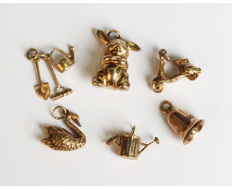 Six 9ct gold charms, comprising scooter, rabbit, bell, swan, watering can and garden implements, total weight 9.6g.Buyer’s Pr