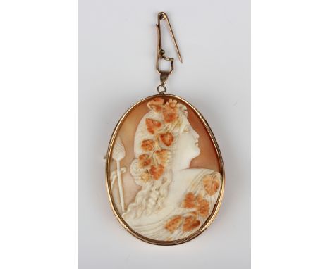 A Victorian gold mounted oval shell cameo brooch, carved as a portrait of a classical lady with fruiting vines in her hair, u