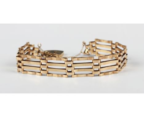 A 9ct gold bar and oval link gate bracelet on a gold heart shaped padlock clasp, London 1977, weight 9.1g.Buyer’s Premium 29.