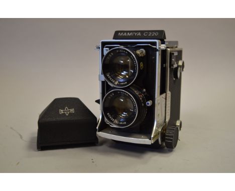 A Mamiya C220 Medium Format TLR Camera, with Mamiya/Sekor 80mm f/2.8 lens, shutter sticking, lugs damaged on prism view finde