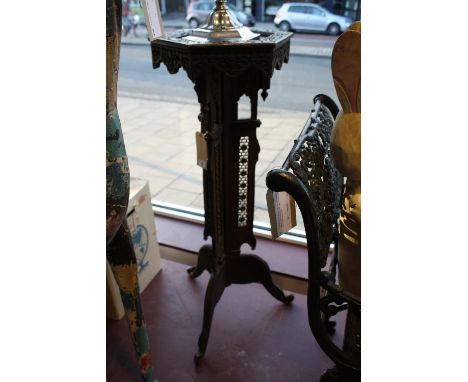 A damascan carved hardwood jardiniere stand with hexagonal top on triangular column and tripod, H. 102cm.