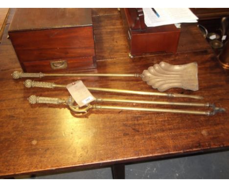 A set of three early 20th century brass fire tools, with diamond trellis cast handles, (3)