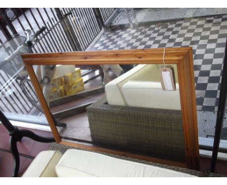 A rectangular pine cushion framed wall mirror by Morris Mirrors, H. 101cm