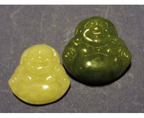 A carved green jade buddah, H. 3cm, together with a similar mutton-fat jade example, (2)