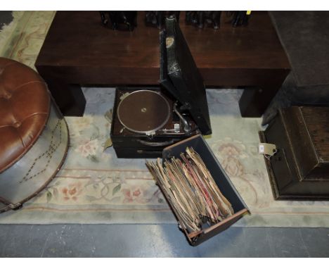 An early 20th century HMV portable wind-up gramophone; together with a similar later Decca gramophone and a case of 78rpm rec