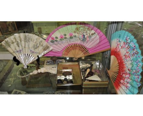 An early 20th Century painted embroidered silk fan with mother of pearl sticks, a Victorian silver piquet work tortoiseshell 