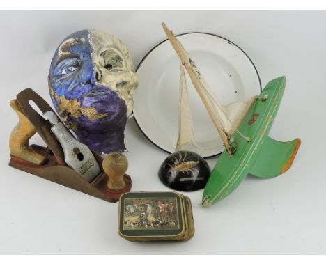 A Star brand green painted child's pond yacht, wooden with a steel keel, L. 29cm; together with papier-mache face mask, two e