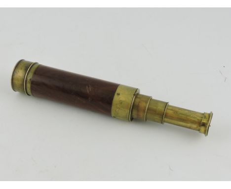 A late Victorian lacquered brass three drawer small telescope with hardwood outer cover, lens cover and sliding eyepiece, fir