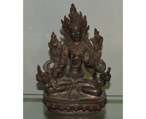 A gilt bronze model of Vishnu seated cross legged on a lotus cushion. H. 13cm.