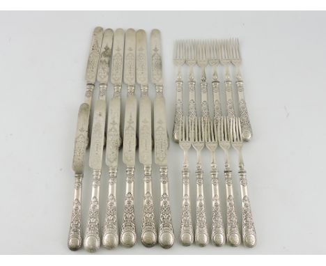 A set of Victorian silver fruit eaters, Sheffield 1899, for 12 place settings (lacking one fork), with foliate blades and han