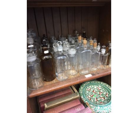 SHELF OF GLASS CHEMISTS BOTTLES ETC.   