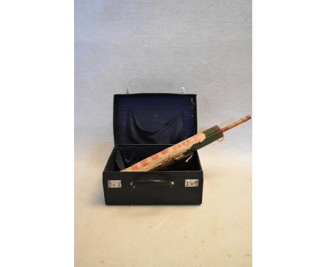 A vintage leather travelling case along with a Chinese parasol unopened and in its original wrapping. L.70cm 